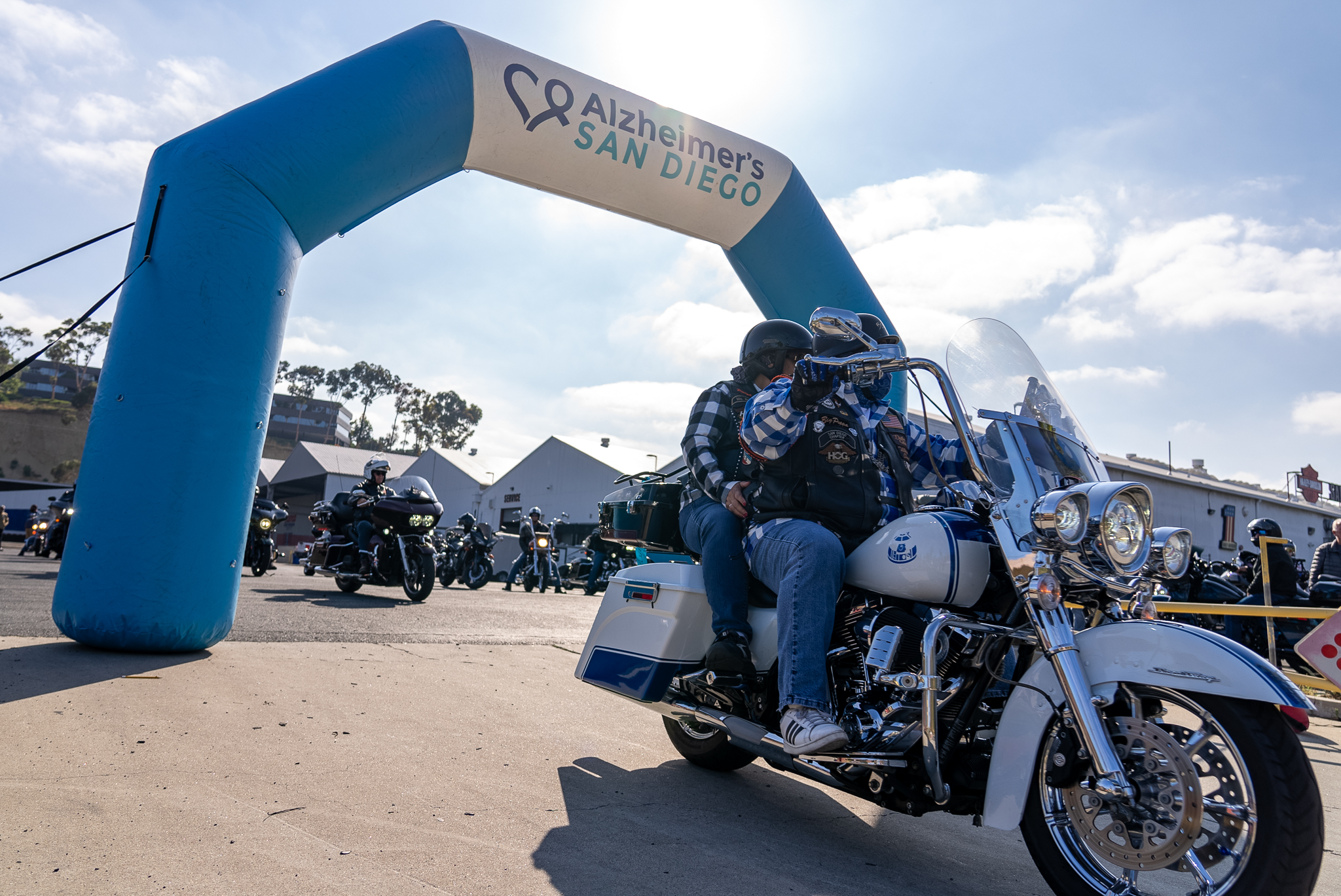 Motorcyclist riding under the Alzheimer's San Diego Rides4ALZ archway