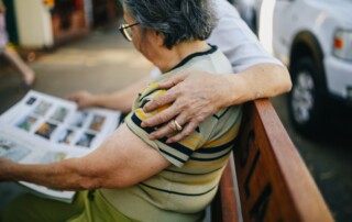 Man hugging partner on bench